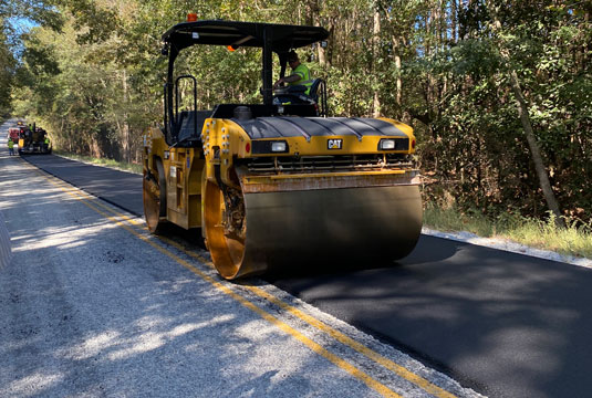 SmartMix being applied to a road by a steam roller