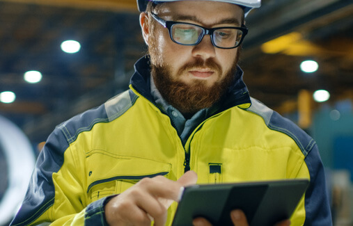 A man looking over an Ipad