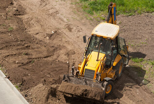 A bulldozer lifting up dirt
