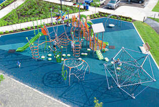 A playground resting on top of blue rubber turf
