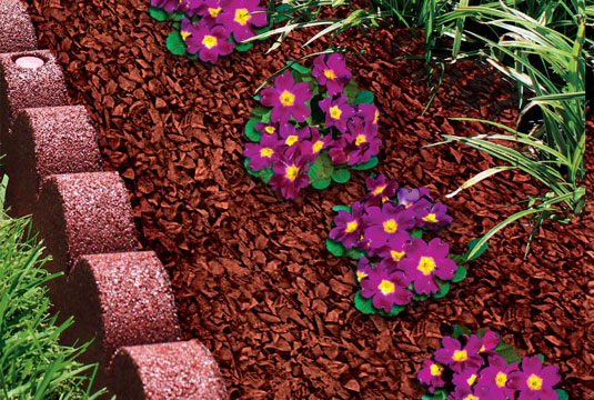 GroundSmart Rubber Mulch Nuggets in a flower bed