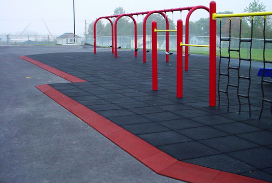 KidKushion mats installed around swings and other playground equipment