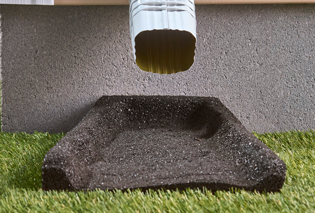 Lasting Beauty Splash Block under a gutter spout