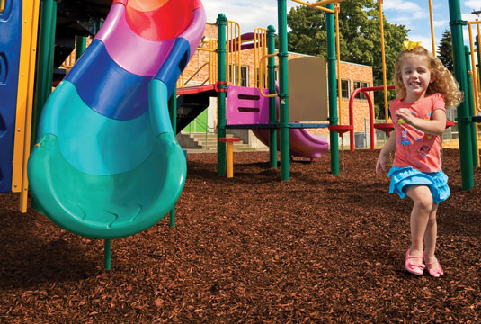 A Girl running on playground with NuPlay Nuggets installed