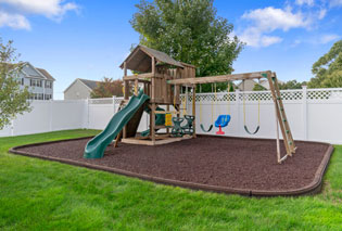 A playground with Playsafer Rubber Curb installed around it