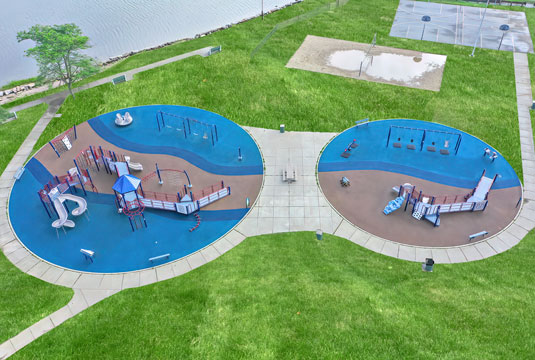 An areal view of two playgrounds with RubberBond installed