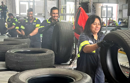 An Liberty Tire employees inspecting used tires