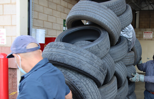 LTR employees stacking donated tires