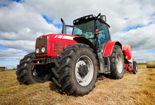 A red tractor sitting in a field