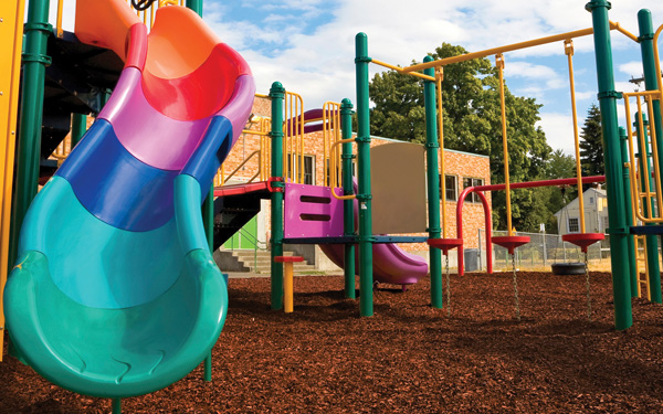A playground surrounded by rubber mulch