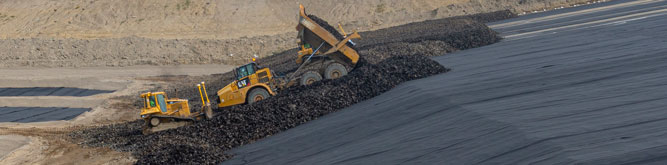 Construction vehicles moving tire-derived aggregate