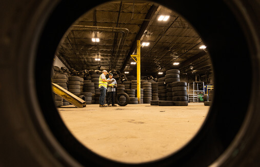A shot of LTR employees standing in a tire warehouse