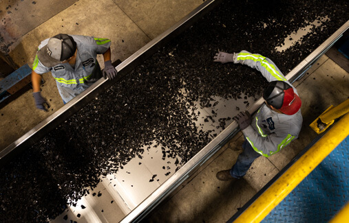 An aerial view of LTR employees sorting shredded rubber 