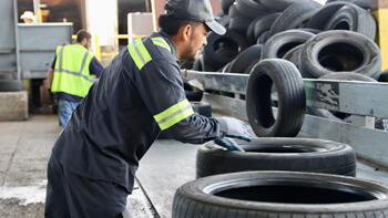 An LTR employee gathering tires