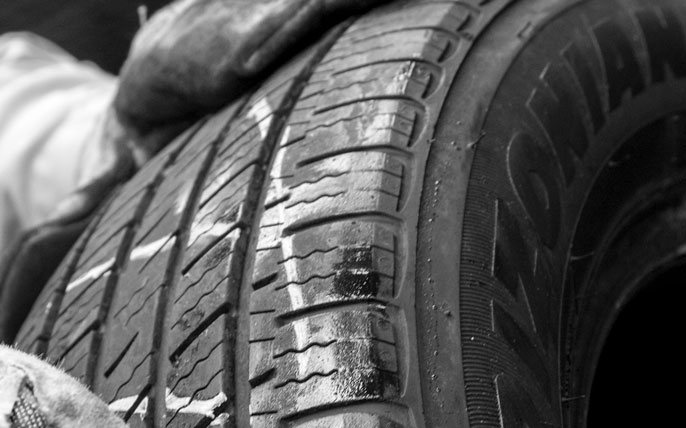A close up of treads on a used tire