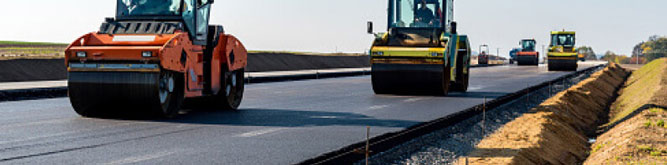 Pavers flattening asphalt on a road